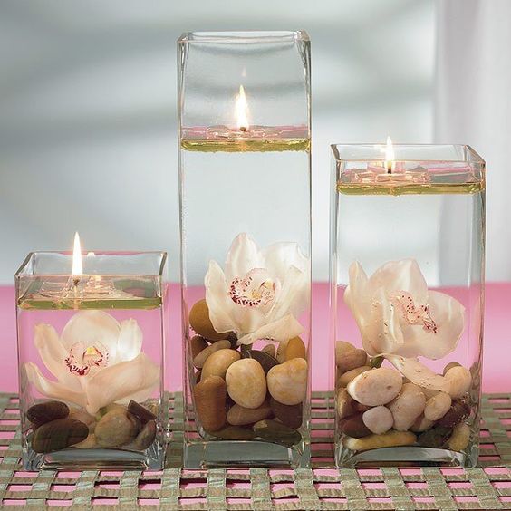 3 candele in vaso con olio e sassolini